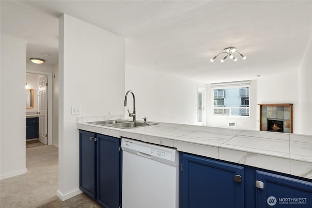 10501 8th Ave NE Unit 334, Seattle, WA 98125 - kitchen with dishwasher, blue cabinetry, light colored carpet, and a tile fireplace