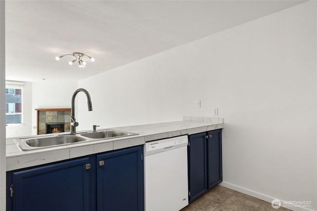 10501 8th Ave NE Unit 334, Seattle, WA 98125 - kitchen featuring white dishwasher, blue cabinetry, a fireplace, light countertops, and light tile patterned flooring