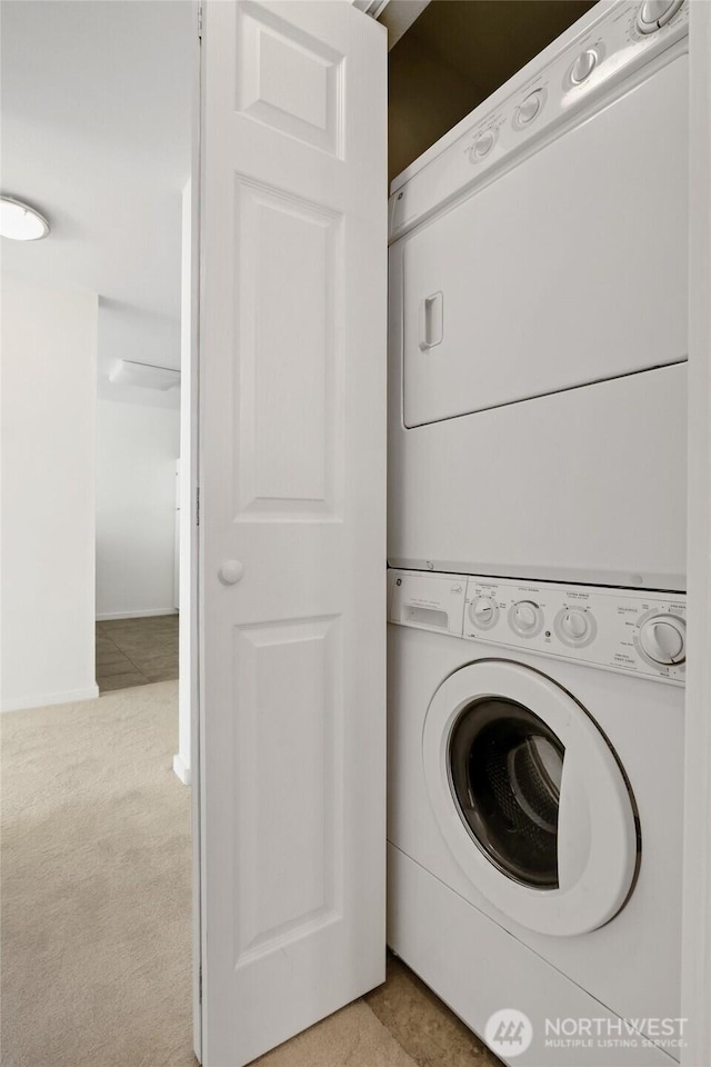 10501 8th Ave NE Unit 334, Seattle, WA 98125 - washroom with stacked washer and clothes dryer and light carpet