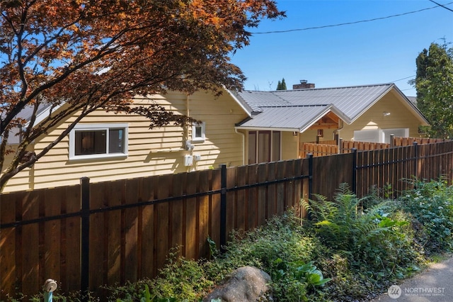 10843 Point Vashon Dr SW, Vashon, WA 98070 - view of side of home with a metal roof and a chimney