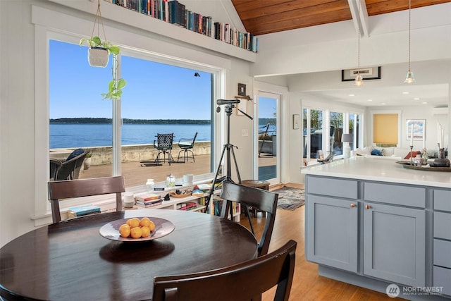 10843 Point Vashon Dr SW, Vashon, WA 98070 - dining room with light wood-style floors, a water view, and lofted ceiling