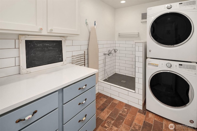 10843 Point Vashon Dr SW, Vashon, WA 98070 - laundry area featuring stacked washer / drying machine, recessed lighting, and brick patterned flooring