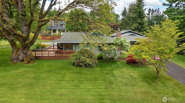 1323 216th Ave NE, Sammamish, WA 98074 - rear view of property with a wooden deck, a yard, and roof with shingles
