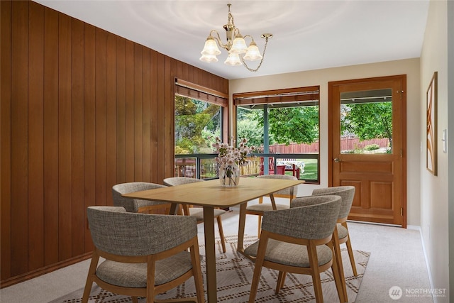 1323 216th Ave NE, Sammamish, WA 98074 - dining space featuring healthy amount of natural light, a chandelier, wood walls, and light carpet