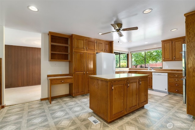 1323 216th Ave NE, Sammamish, WA 98074 - kitchen with white appliances, ceiling fan, recessed lighting, light countertops, and brown cabinets