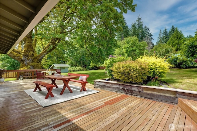 1323 216th Ave NE, Sammamish, WA 98074 - wooden deck with outdoor dining space, a lawn, a storage shed, and view of scattered trees