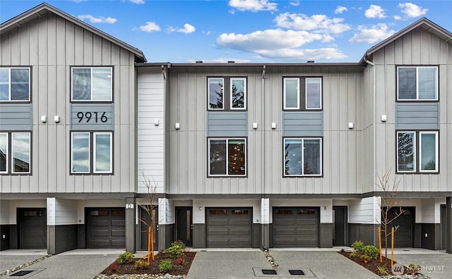 16111 36th Ave W Unit A1, Lynnwood, WA 98087 - view of building exterior with an attached garage and driveway