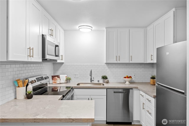 13932 NE 60th St Unit 150, Redmond, WA 98052 - kitchen featuring appliances with stainless steel finishes, white cabinetry, and backsplash
