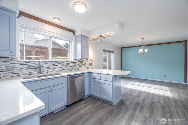 2460 Pine Dr, Ferndale, WA 98248 - kitchen with dishwasher, a peninsula, light countertops, and decorative backsplash