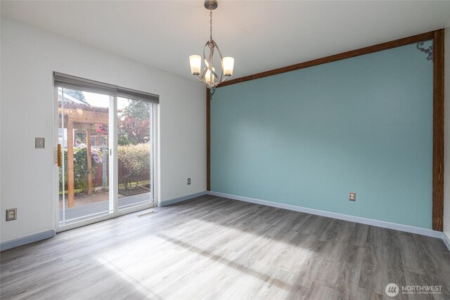 2460 Pine Dr, Ferndale, WA 98248 - spare room featuring wood finished floors and a chandelier