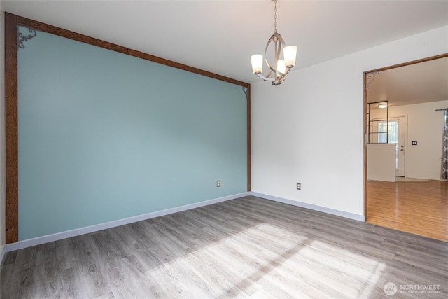 2460 Pine Dr, Ferndale, WA 98248 - empty room featuring wood finished floors and a chandelier