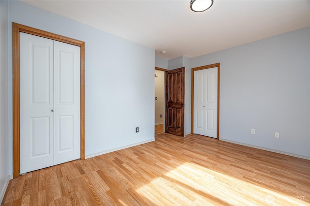 2460 Pine Dr, Ferndale, WA 98248 - unfurnished bedroom featuring light wood finished floors and two closets