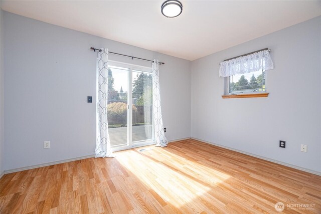 2460 Pine Dr, Ferndale, WA 98248 - empty room with wood finished floors and healthy amount of natural light