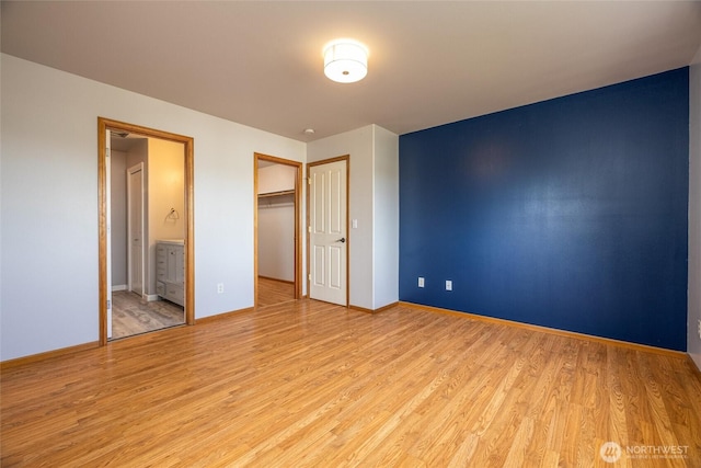 2460 Pine Dr, Ferndale, WA 98248 - unfurnished bedroom with light wood-style flooring, connected bathroom, and a closet