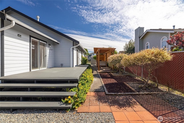 2460 Pine Dr, Ferndale, WA 98248 - view of side of home featuring a deck, a patio, and a chimney