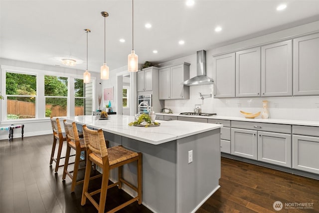 305 Field Pl SE, Renton, WA 98059 - kitchen with wall chimney exhaust hood, gray cabinets, recessed lighting, dark wood-style flooring, and light stone countertops
