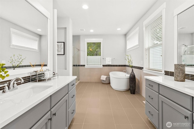 305 Field Pl SE, Renton, WA 98059 - full bathroom featuring a shower stall, tile walls, a wainscoted wall, two vanities, and a freestanding bath