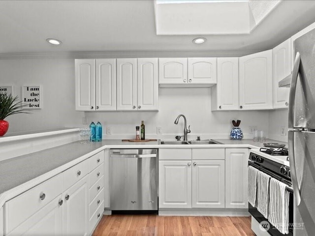 3601 S Spokane St Unit 1-1, Seattle, WA 98144 - kitchen with appliances with stainless steel finishes, recessed lighting, white cabinets, light countertops, and crown molding