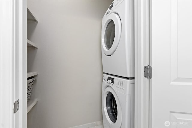 14335 Simonds Rd NE Unit A305, Kirkland, WA 98034 - washroom featuring stacked washing machine and dryer and baseboards