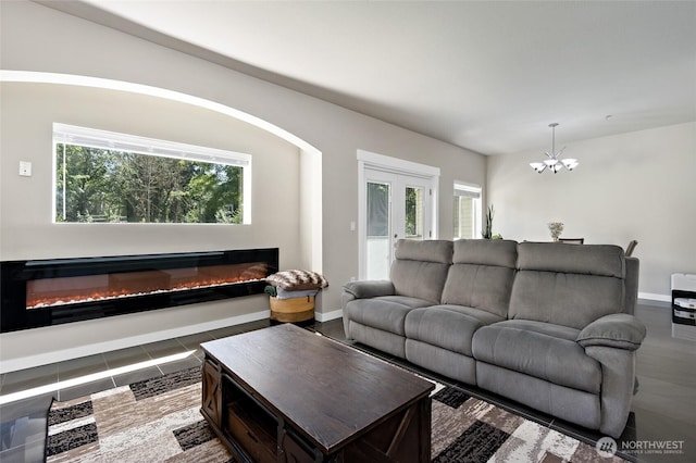 14335 Simonds Rd NE Unit A305, Kirkland, WA 98034 - living room with a glass covered fireplace, a chandelier, and plenty of natural light