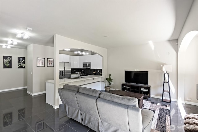 14335 Simonds Rd NE Unit A305, Kirkland, WA 98034 - living area with arched walkways, dark tile patterned floors, and a chandelier
