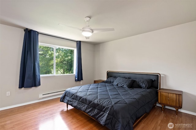 14335 Simonds Rd NE Unit A305, Kirkland, WA 98034 - bedroom featuring a baseboard heating unit, wood finished floors, and ceiling fan