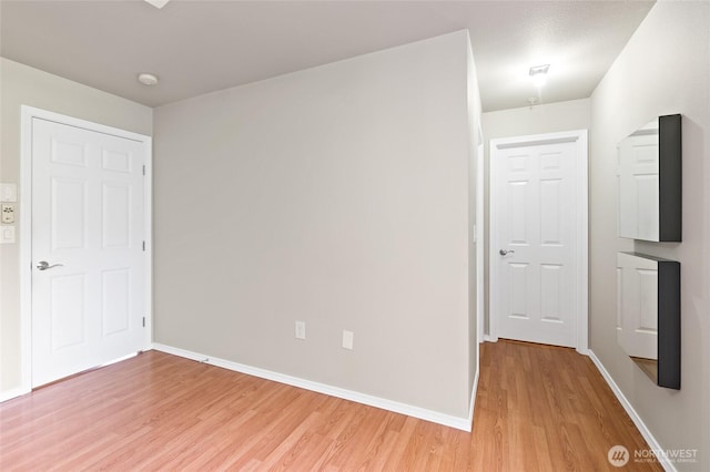 14335 Simonds Rd NE Unit A305, Kirkland, WA 98034 - unfurnished bedroom with light wood finished floors and baseboards