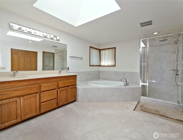 22019 NE 26th Pl, Sammamish, WA 98074 - full bath with double vanity, a stall shower, a garden tub, a skylight, and recessed lighting