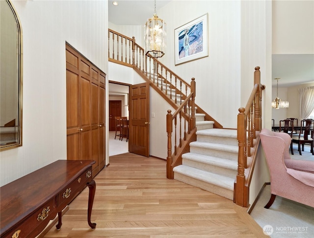 22019 NE 26th Pl, Sammamish, WA 98074 - entrance foyer featuring a chandelier, light wood-style flooring, stairs, and a towering ceiling