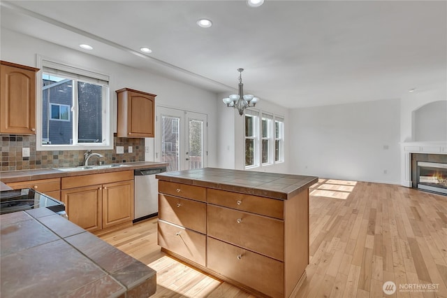 7003 Radius Loop SE, Lacey, WA 98513 - kitchen with dishwasher, tile counters, light wood-style floors, healthy amount of natural light, and recessed lighting