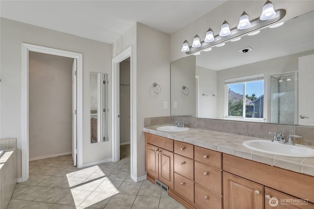 7003 Radius Loop SE, Lacey, WA 98513 - full bath with double vanity, tile patterned floors, a spacious closet, and a shower with door
