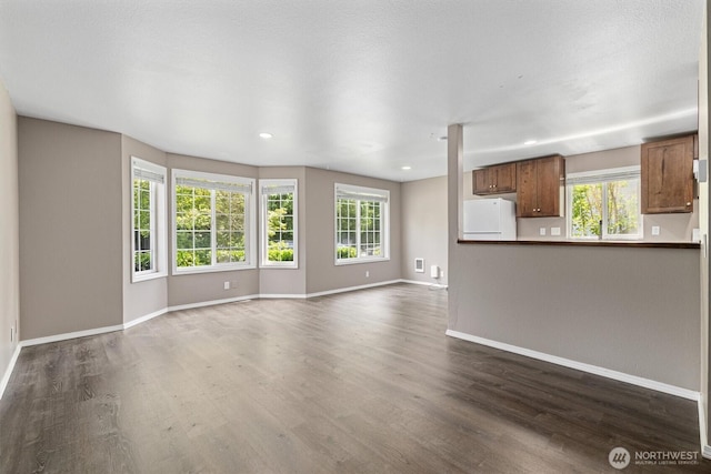 507 Madison Ave, Everett, WA 98203 - unfurnished living room featuring dark wood-type flooring and recessed lighting