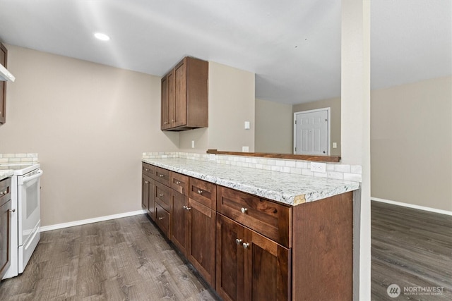 507 Madison Ave, Everett, WA 98203 - kitchen featuring white electric range, dark wood-style flooring, and a peninsula