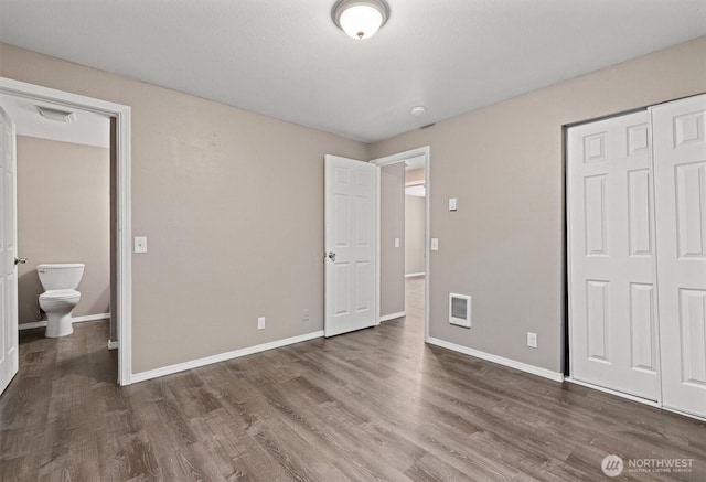507 Madison Ave, Everett, WA 98203 - unfurnished bedroom featuring wood finished floors, a closet, and heating unit