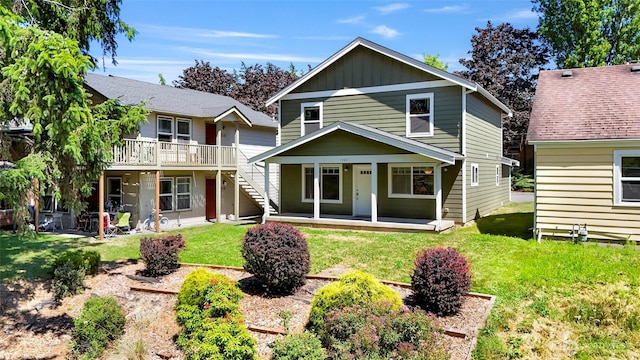 1422 Lincoln St, Bellingham, WA 98229 - rear view of house featuring a lawn, board and batten siding, a porch, a wooden deck, and stairway