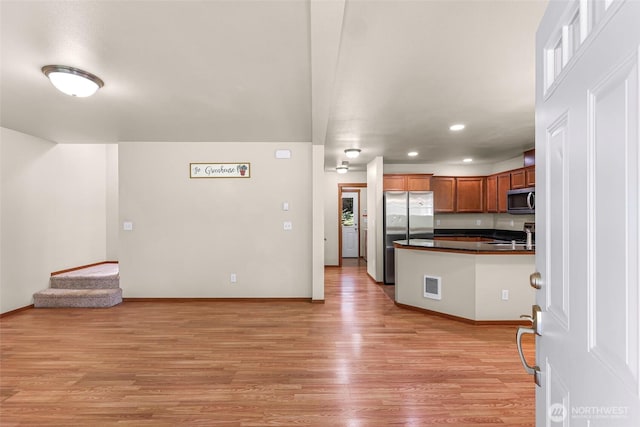 1422 Lincoln St, Bellingham, WA 98229 - kitchen with appliances with stainless steel finishes, dark countertops, light wood-style flooring, recessed lighting, and a peninsula