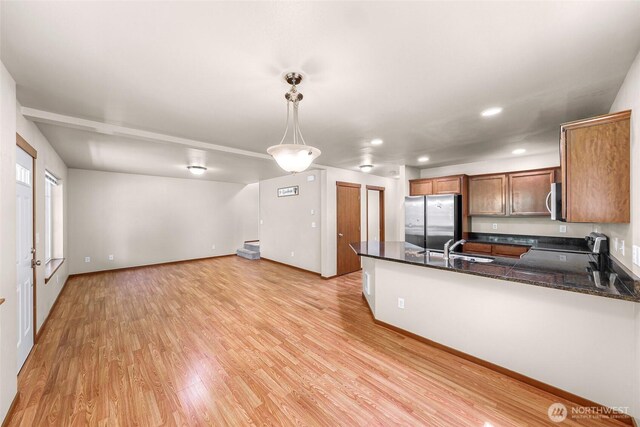 1422 Lincoln St, Bellingham, WA 98229 - kitchen featuring stainless steel appliances, a peninsula, hanging light fixtures, light wood finished floors, and recessed lighting