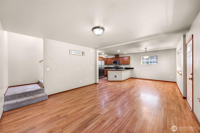 1422 Lincoln St, Bellingham, WA 98229 - unfurnished living room featuring light wood finished floors and stairway