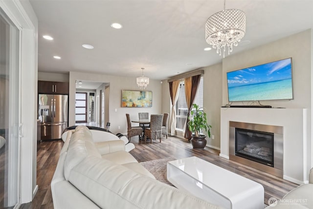 5624 S 344th Ct, Auburn, WA 98001 - living area with a chandelier, healthy amount of natural light, wood finished floors, recessed lighting, and a glass covered fireplace