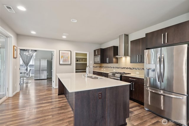 5624 S 344th Ct, Auburn, WA 98001 - kitchen with appliances with stainless steel finishes, wall chimney exhaust hood, wood finished floors, light countertops, and recessed lighting