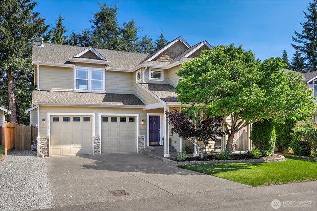 13034 SE 209th Ct, Kent, WA 98031 - view of front of house featuring concrete driveway, an attached garage, roof with shingles, and stone siding