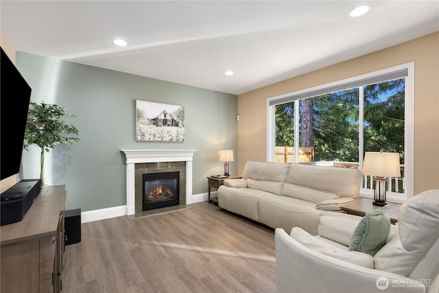 13034 SE 209th Ct, Kent, WA 98031 - living area featuring wood finished floors, a tile fireplace, and recessed lighting