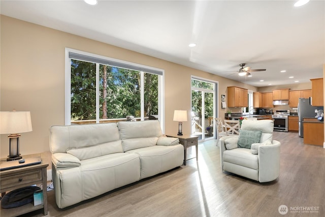 13034 SE 209th Ct, Kent, WA 98031 - living room featuring a ceiling fan, recessed lighting, and light wood-style flooring