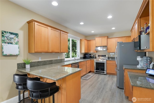 13034 SE 209th Ct, Kent, WA 98031 - kitchen with stainless steel appliances, a peninsula, under cabinet range hood, recessed lighting, and light wood-style flooring