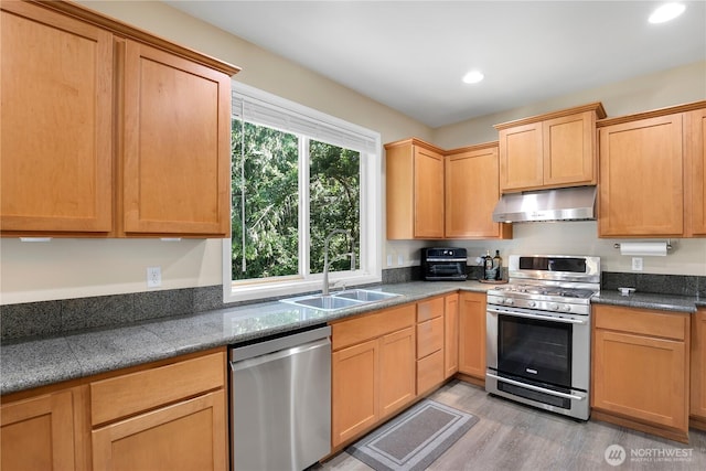 13034 SE 209th Ct, Kent, WA 98031 - kitchen with appliances with stainless steel finishes, ventilation hood, light wood-type flooring, recessed lighting, and light brown cabinetry