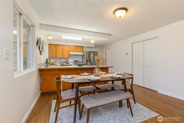 17114 SE 130th Ave, Renton, WA 98058 - dining space featuring wood finished floors and a textured ceiling