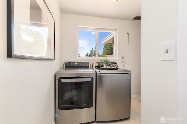 17114 SE 130th Ave, Renton, WA 98058 - washroom with washing machine and clothes dryer and light tile patterned floors