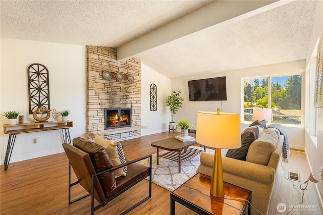 17114 SE 130th Ave, Renton, WA 98058 - living area with a textured ceiling, a fireplace, and wood finished floors