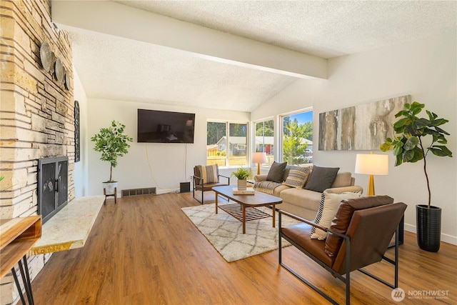 17114 SE 130th Ave, Renton, WA 98058 - living room with a textured ceiling, wood finished floors, and a fireplace
