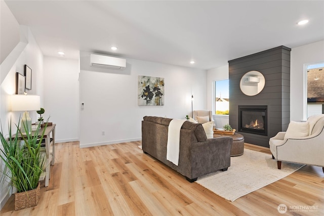251 Sweet Gum Dr, Blaine, WA 98230 - living area with a wall mounted air conditioner, light wood-type flooring, a fireplace, and recessed lighting